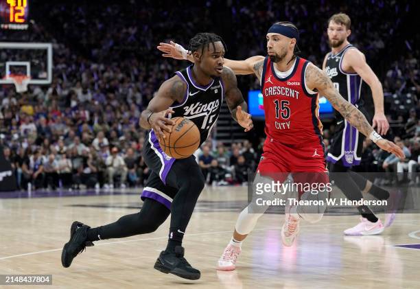 Davion Mitchell of the Sacramento Kings drives on Jose Alvarado of the New Orleans Pelicans during the second half of an NBA basketball game at...
