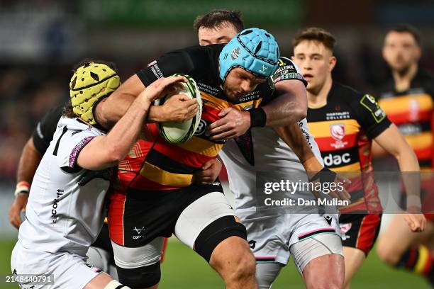 Zach Mercer of Gloucester Rugby is tackled by Harri Deaves and Sam Parry of Ospreys during the EPCR Challenge Cup Quarter Final match between...