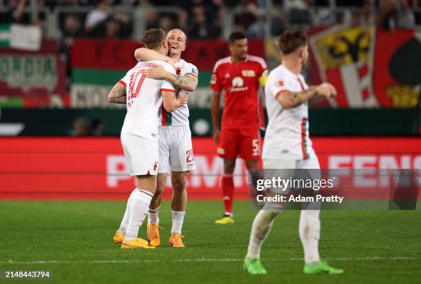 Sven Michel of FC Augsburg celebrates with teammate Arne Maier after scoring his team's second goal during the Bundesliga match between FC Augsburg...