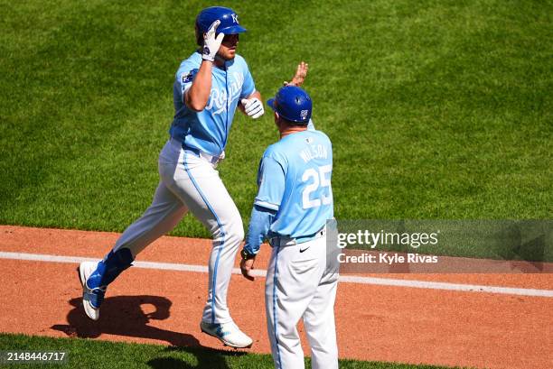 Hunter Renfroe of the Kansas City Royals celebrates hitting a home run against the Chicago White Sox with Vance Wilson during the fifth inning at...