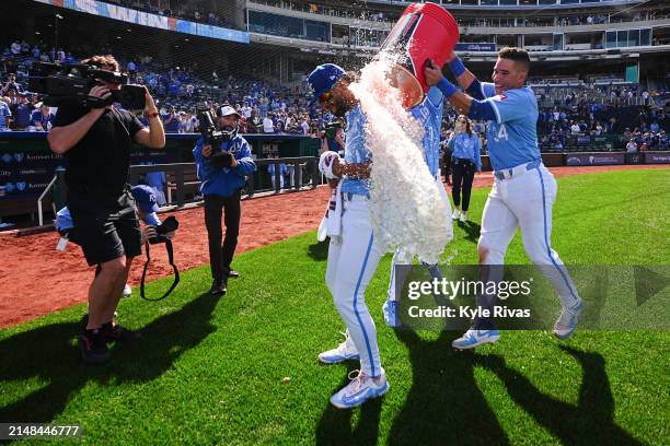 Melendez of the Kansas City Royals gets splashed by Freddy Fermin and Bobby Witt Jr. #7 after defeating the Chicago White Sox at Kauffman Stadium on...