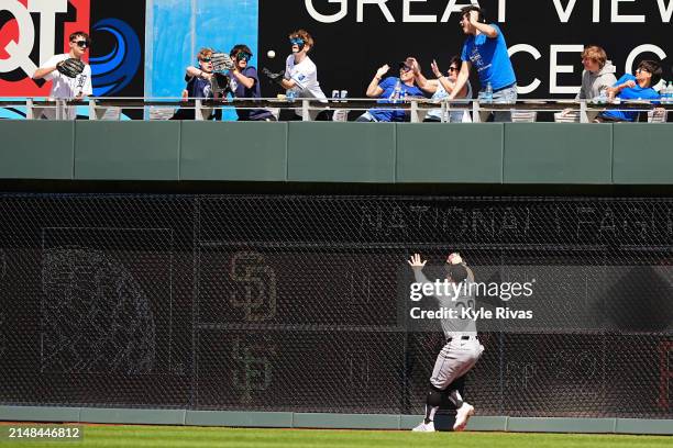 Fan catches a home run ball hit by MJ Melendez of the Kansas City Royals as Robbie Grossman of the Chicago White Sox looks on during the seventh...