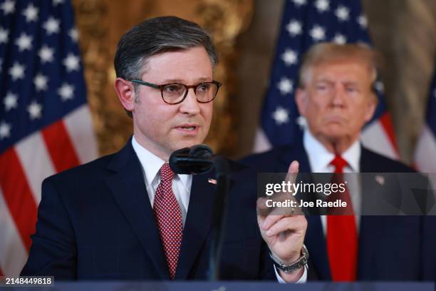 Republican presidential candidate former President Donald Trump listens as Speaker of the House Mike Johnson speaks during a press conference at Mr....