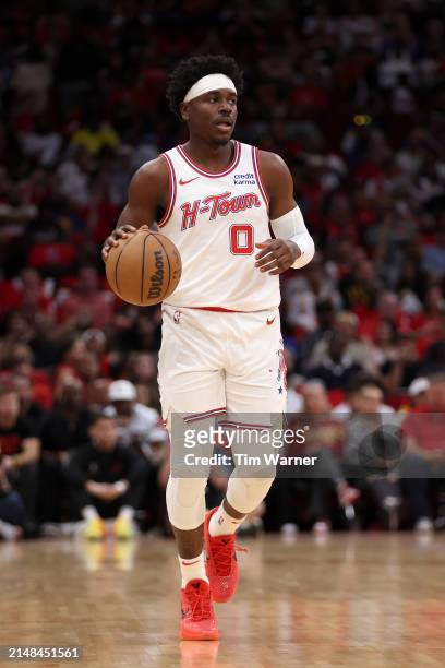 Aaron Holiday of the Houston Rockets brings the ball up court in the second half against the Golden State Warriors at Toyota Center on April 04, 2024...