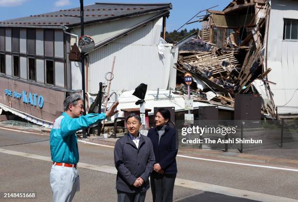 Emperor Naruhito and Empress Masako listen to explanation at a destroyed shopping street on April 12, 2024 in Anamizu, Ishikawa, Japan.
