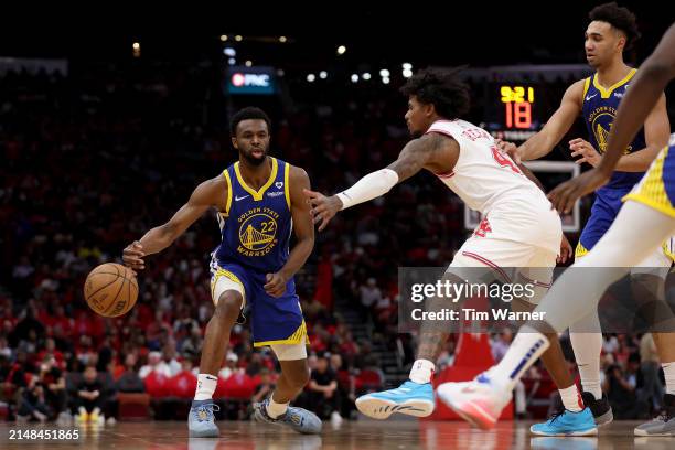 Andrew Wiggins of the Golden State Warriors passes the ball while defended by Jalen Green of the Houston Rockets in the second half at Toyota Center...