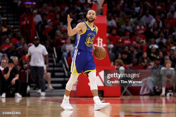 Stephen Curry of the Golden State Warriors brings the ball up court in the second half against the Houston Rockets at Toyota Center on April 04, 2024...