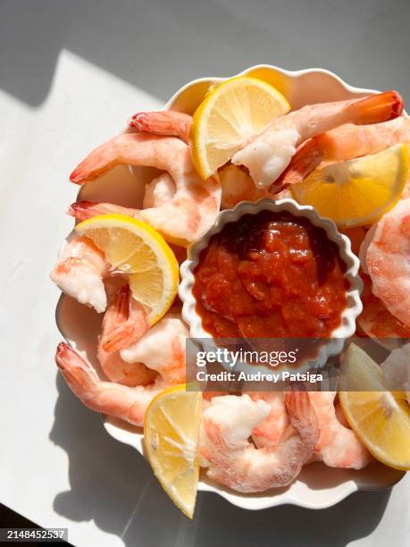 shrimp cocktail appetizer and lemon wedges in a scallop trimmed bowl - prawn cocktail stock pictures, royalty-free photos & images