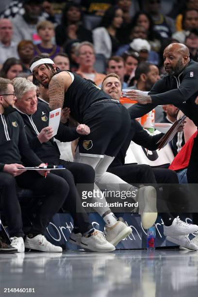 Timmy Allen of the Memphis Grizzlies crashes into the bench during the first half against the Los Angeles Lakers at FedExForum on April 12, 2024 in...