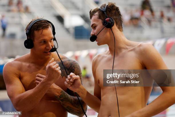 Caeleb Dressel reacts with Hubert Kos after they tied for first place in the Women's 100m Butterfly final on Day 3 of the TYR Pro Swim Series San...