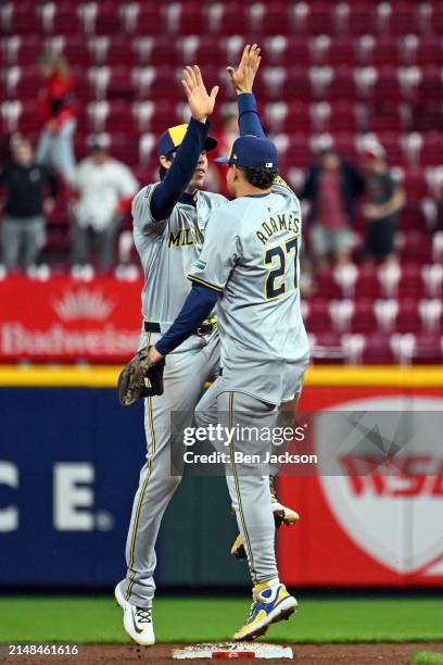 Christian Yelich of the Milwaukee Brewers celebrates with teammate Willy Adames of the Milwaukee Brewers after defeating the Cincinnati Reds 9-5 in a...