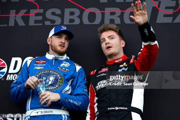 Stefan Parsons, driver of the Trophy Tractor Chevrolet, and Ty Dillon, driver of the Rackley Roofing Chevrolet, talk backstage during pre-race...