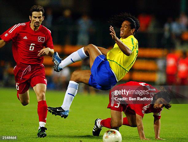 Ronaldinho of Brazil is fouled by Bulent Korkmaz of Turkey during the Confederation Cup Group B match between Brazil and Turkey on June 23, 2003 at...