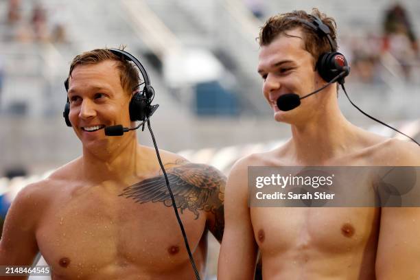 Caeleb Dressel reacts with Hubert Kos after they tied for first place in the Women's 100m Butterfly final on Day 3 of the TYR Pro Swim Series San...