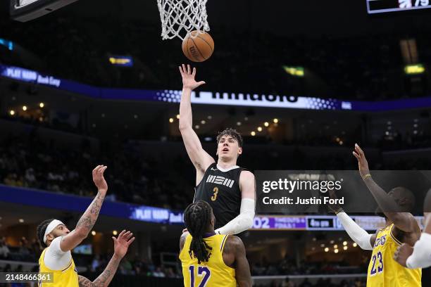 Jake LaRavia of the Memphis Grizzlies goes to the basket against Taurean Prince of the Los Angeles Lakers during the second half at FedExForum on...