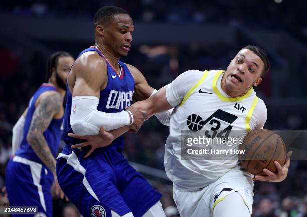 Kenneth Lofton Jr. #34 of the Utah Jazz reacts as he is fouled by Russell Westbrook of the LA Clippers during the first half at Crypto.com Arena on...