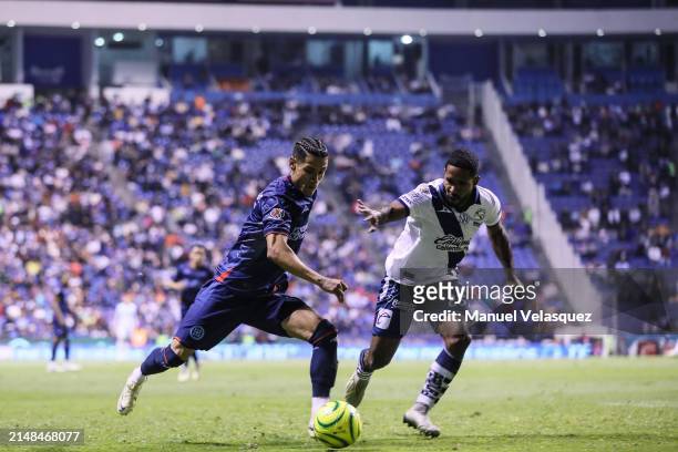 Uriel Antuna of Cruz Azul battles for the ball against Brayan Angulo of Puebla during the 15th round match between Puebla and Cruz Azul as part of...