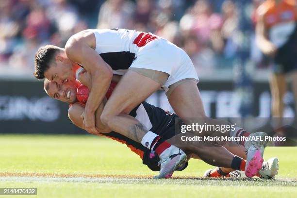 Xavier O'Halloran of the Giants is tackled by Josh Battle of the Saints during the round five AFL match between Greater Western Sydney Giants and St...