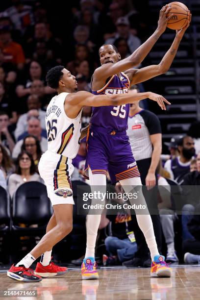 Kevin Durant of the Phoenix Suns posts up on Trey Murphy III of the New Orleans Pelicans during the game at Footprint Center on April 07, 2024 in...