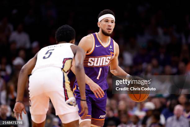 Devin Booker of the Phoenix Suns dribbles during the game against the New Orleans Pelicans at Footprint Center on April 07, 2024 in Phoenix, Arizona....