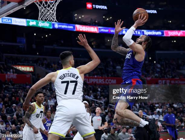 Amir Coffey of the LA Clippers attempts a shot in front of Omer Yurtseven of the Utah Jazz during a 110-109 loss to the Utah Jazz at Crypto.com Arena...