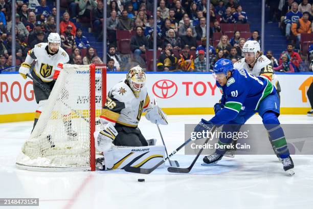 Logan Thompson of the Vegas Golden Knights makes a save on Dakota Joshua of the Vancouver Canucks during the first period of their NHL game at Rogers...