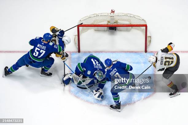 Tyler Myers Arturs Silovs and Carson Soucy of the Vancouver Canucks defend against Keegan Kolesar and Brett Howden of the Vegas Golden Knights during...