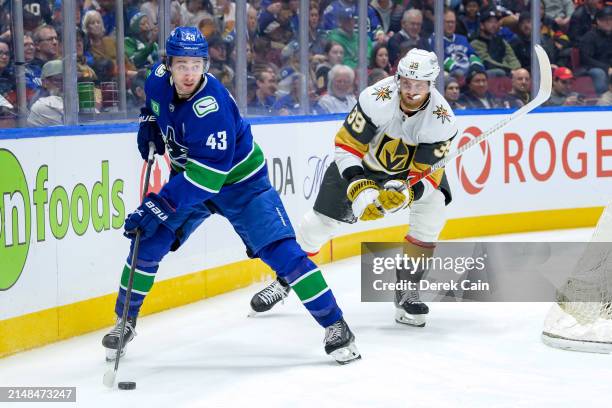 Quinn Hughes of the Vancouver Canucks is pursued by Anthony Mantha of the Vegas Golden Knights during the second period of their NHL game at Rogers...