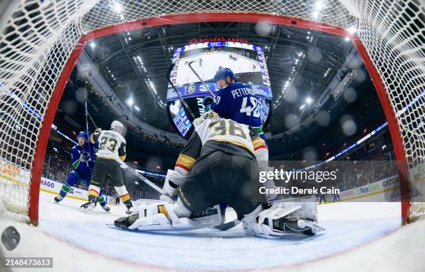 Elias Pettersson watches a goal by Brock Boeser of the Vancouver Canucks on Logan Thompson of the Vegas Golden Knights during the second period of...