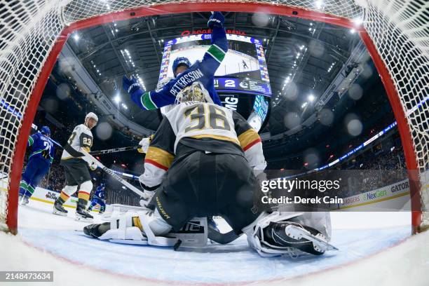 Elias Pettersson watches a goal by Brock Boeser of the Vancouver Canucks on Logan Thompson of the Vegas Golden Knights during the second period of...