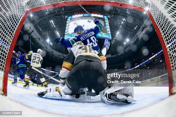 Elias Pettersson watches a goal by Brock Boeser of the Vancouver Canucks on Logan Thompson of the Vegas Golden Knights during the second period of...