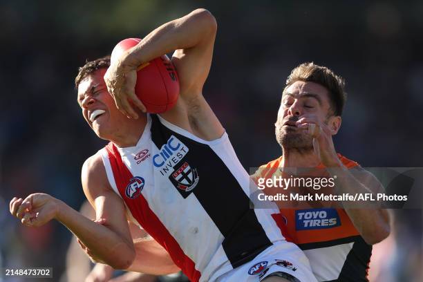 Marcus Windhager of the Saints is tackled by Stephen Coniglio of the Giants during the round five AFL match between Greater Western Sydney Giants and...