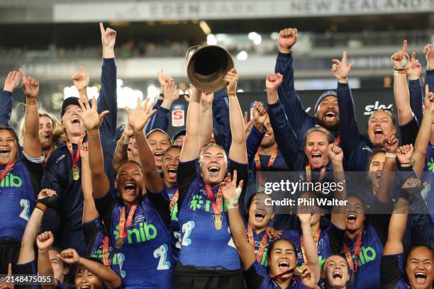 Maia Roos of the Blues holds up the Aupiki Trophy following the Super Rugby Aupiki Final between the Blues and the Chiefs Manawa at Eden Park on...