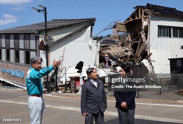 Emperor Naruhito and Empress Masako listen to explanation at a destroyed shopping street on April 12, 2024 in Anamizu, Ishikawa, Japan.