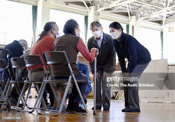 Emperor Naruhito and Empress Masako talk with evacuees at Matsunami Junior High School where local residents take shelter on April 12, 2024 in Noto,...