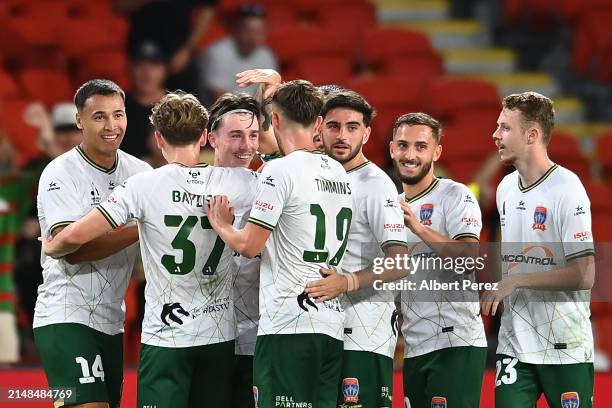 Clayton Taylor of Newcastle celebrates with team mates after scoring a goal during the A-League Men round 24 match between Brisbane Roar and...