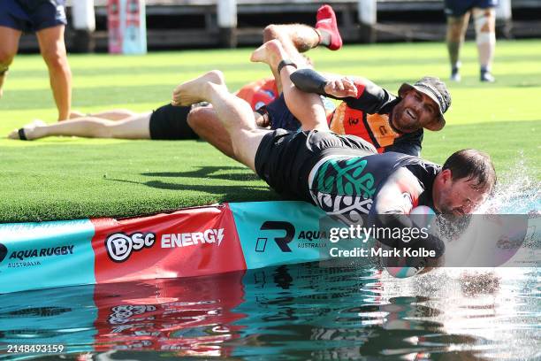 Carl McLeod of New Zealand Māori scores a against the Lloyd McDermott Team during the Aqua Rugby Festival at Darling Harbour on April 13, 2024 in...