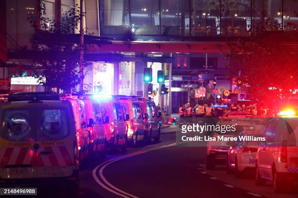 Police and ambulance vehicles line the street outside Westfield Bondi Junction on April 13, 2024 in Bondi Junction, Australia. Six victims, plus the...