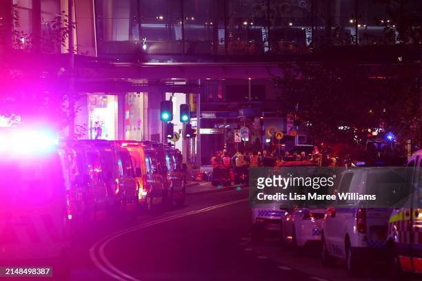 Police and ambulance vehicles line the street outside Westfield Bondi Junction on April 13, 2024 in Bondi Junction, Australia. Six victims, plus the...