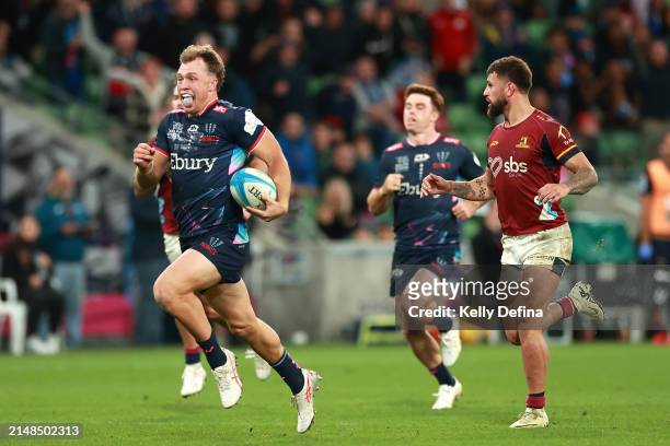 Darby Lancaster of the Rebels makes a break to score a try during the round eight Super Rugby Pacific match between Melbourne Rebels and Highlanders...