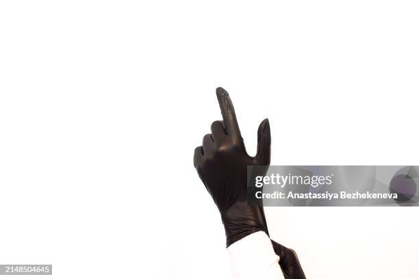 black glove on hand, white background - latex stock pictures, royalty-free photos & images