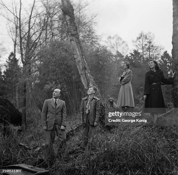 British RAF officer Sir James Robb, the Air Chief Marshal, his wife, Bessie, their son and daughter, birdwatching in woods near their home in the...