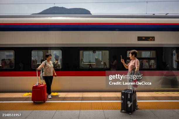Tourists take photos at the Luang Prabang Railway Station on April 12, 2024 in Luang Prabang, Laos. The China-Laos railway, a key project of China's...