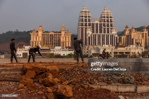 Laos construction workers build a sidewalk in the Boten Special Economic Zone on April 10, 2024 in Boten, Laos. The Boten Special Economic Zone , is...