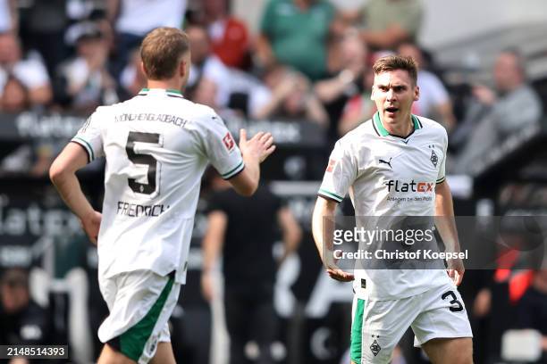 Max Woeber of Borussia Mönchengladbach celebrates scoring his team's first goal with teammate Marvin Friedrich during the Bundesliga match between...