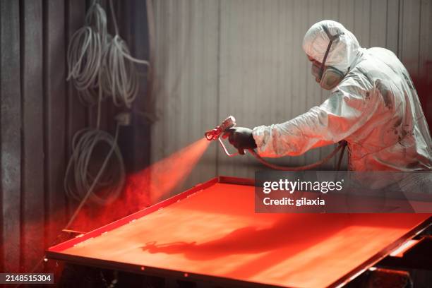 paint job at a factory facility. - red paint splash stock pictures, royalty-free photos & images