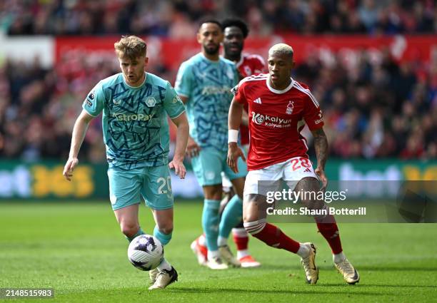 Tommy Doyle of Wolverhampton Wanderers runs with the ball under pressure from Danilo of Nottingham Forest during the Premier League match between...