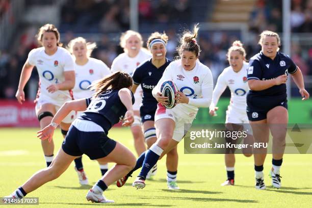 Jess Breach of England beats the tackle of Helen Nelson of Scotland for her second try during the Guinness Women's Six Nations 2024 match between...