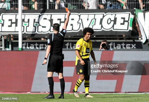 Karim Adeyemi of Borussia Dortmund receives a red card from referee Florian Badstubner during the Bundesliga match between Borussia Mönchengladbach...