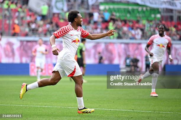 Lois Openda of RB Leipzig celebrates scoring his team's third goal during the Bundesliga match between RB Leipzig and VfL Wolfsburg at Red Bull Arena...